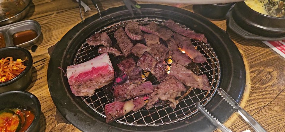 Charcoal grill table in a modern Korean BBQ dining room.
